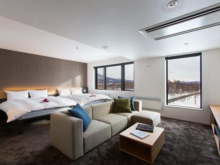 Always Niseko - sofa with 2 beds behind and winter view from window sofa with 2 beds behind and winter view from window