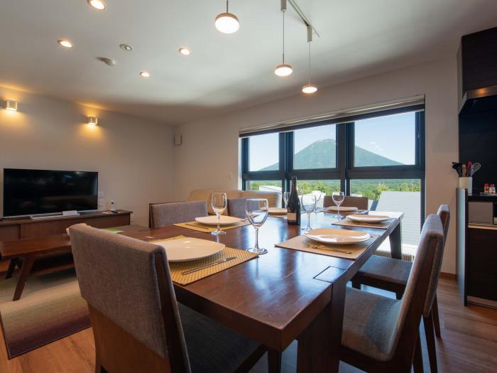 Flow Niseko - dining table set with wine glasses and plates dining table set with wine glasses and plates