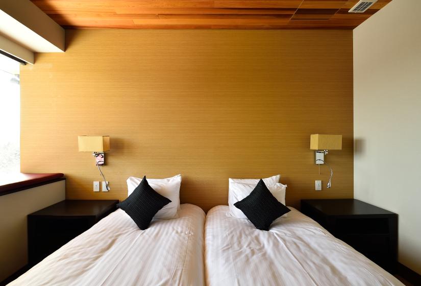 twin beds on yellow wall background