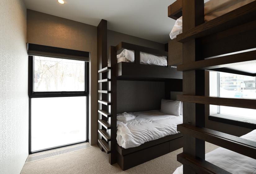 bunk beds with dark stained wood and window