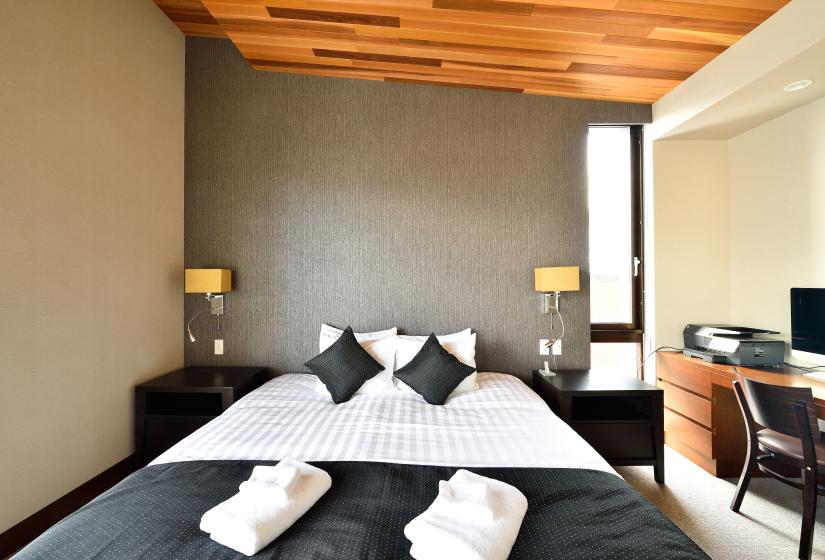 bed with lamps and wood ceiling pannels