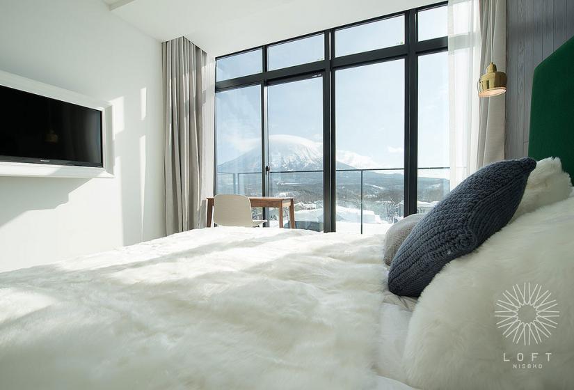 double bed with tv and view of Mt. Yotei