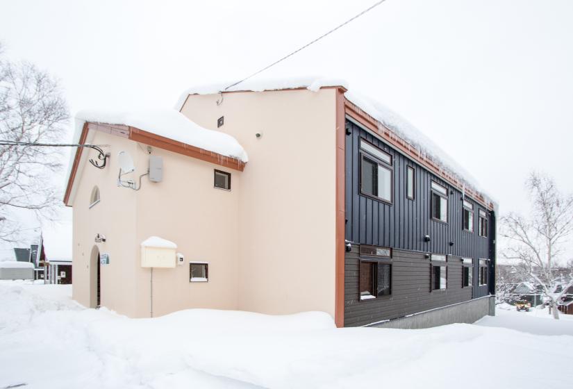 Lodge Mori exterior, snowy roof, cream wall