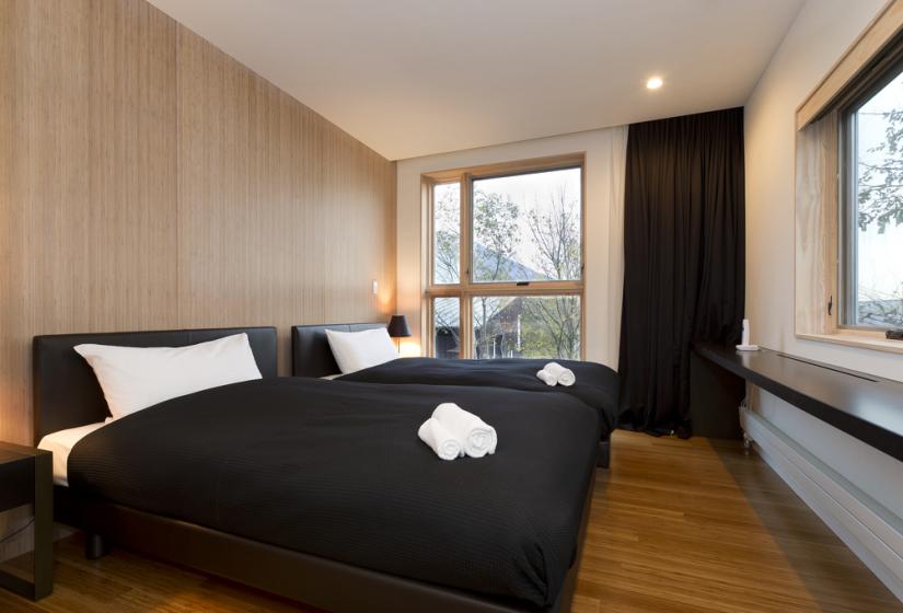 bedroom with 2 single beds with black comforters 