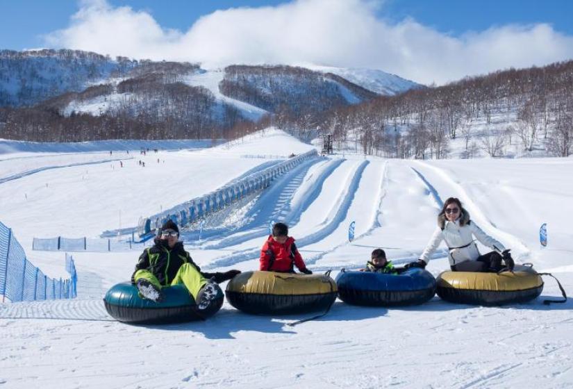 A family enjoys snow tubing