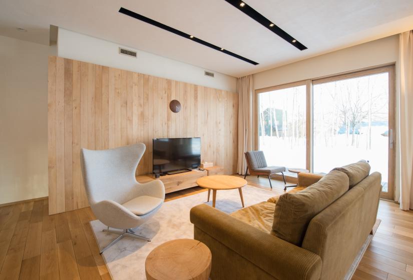 lounge area with a cozy sofa and flat screen tv