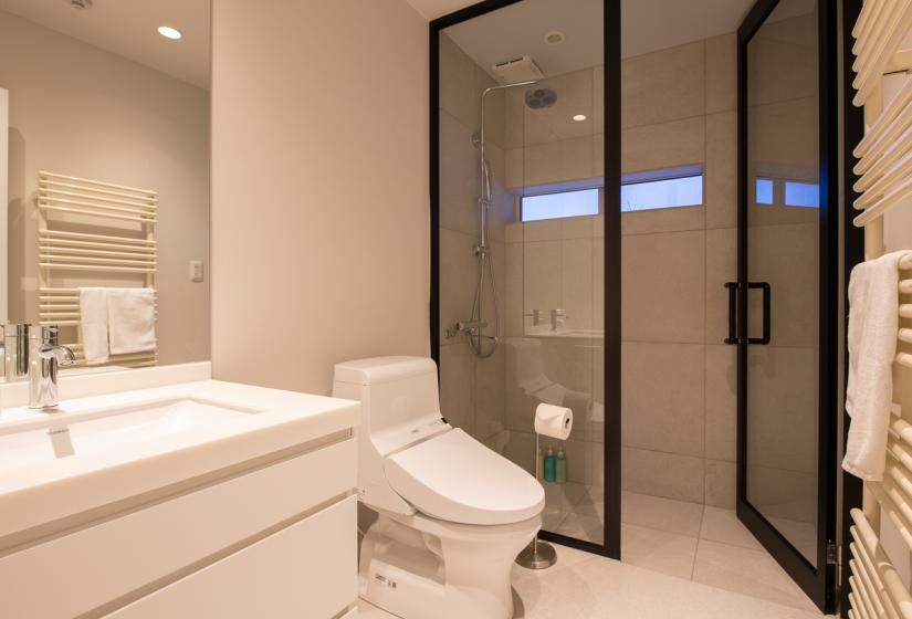 bathroom with shower and white toilet