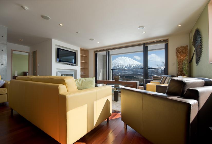 Yellowing sofas facing window with Yotei view