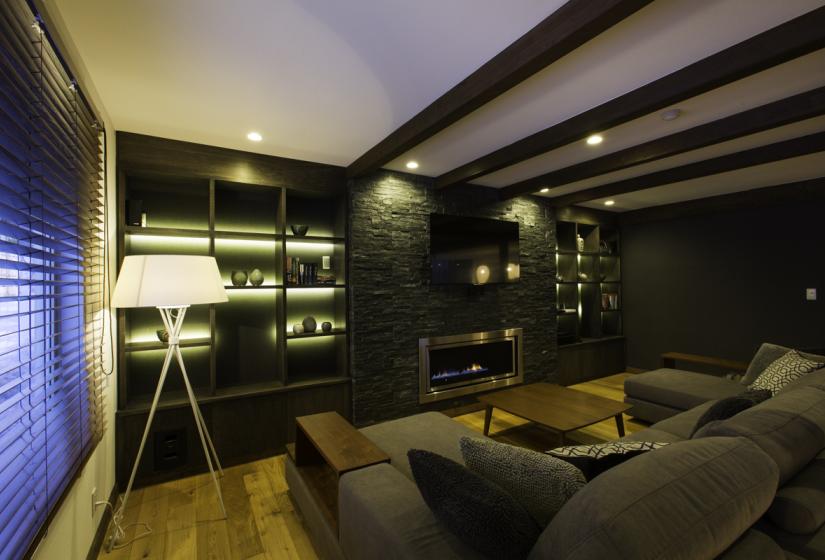 lamp illuminates couch and shelves in living room