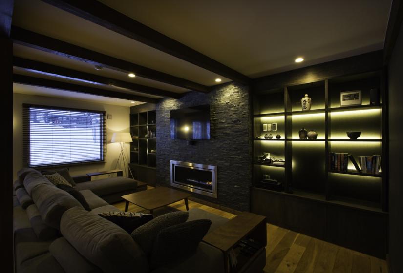 large sofa in front of a fireplace and flat screen tv