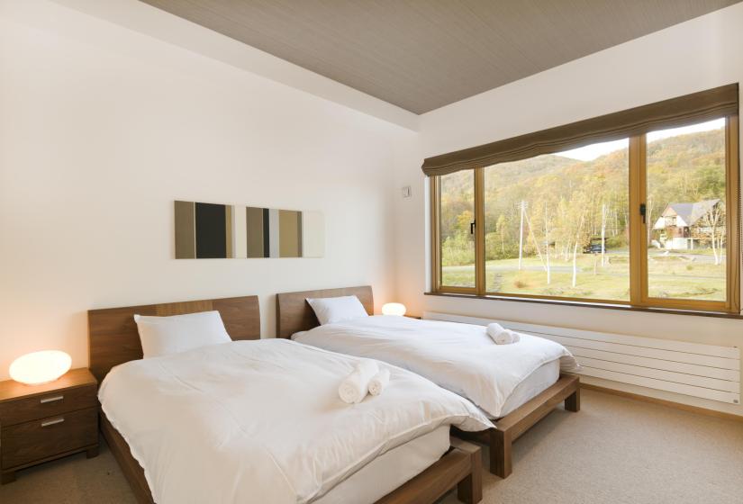 bedroom with 2 single beds and excellent view of forest from window