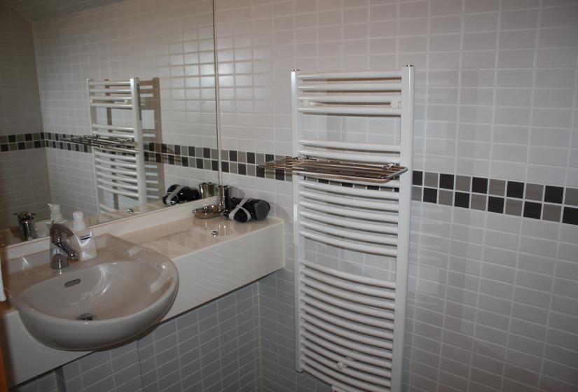 washroom includes sink next to the heater