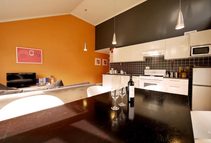 view of the kitchen and living area from the dining table