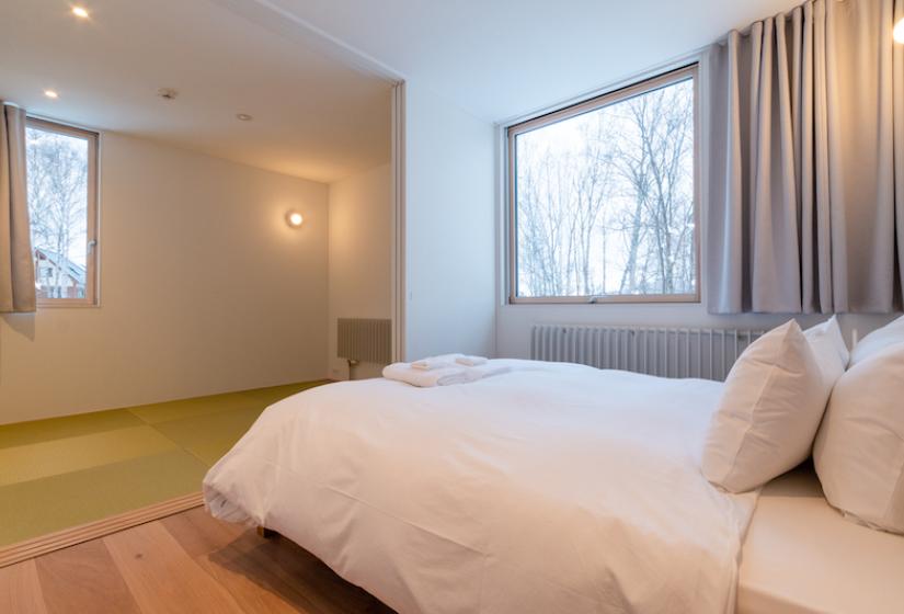 bed in bedroom with tatami area behind