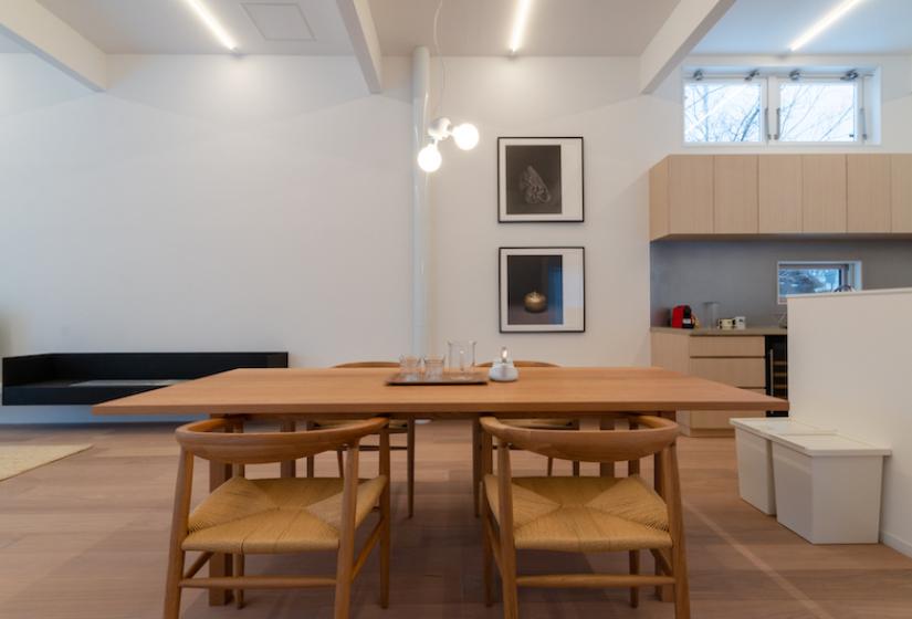 Dining room table and chairs with light fixture above