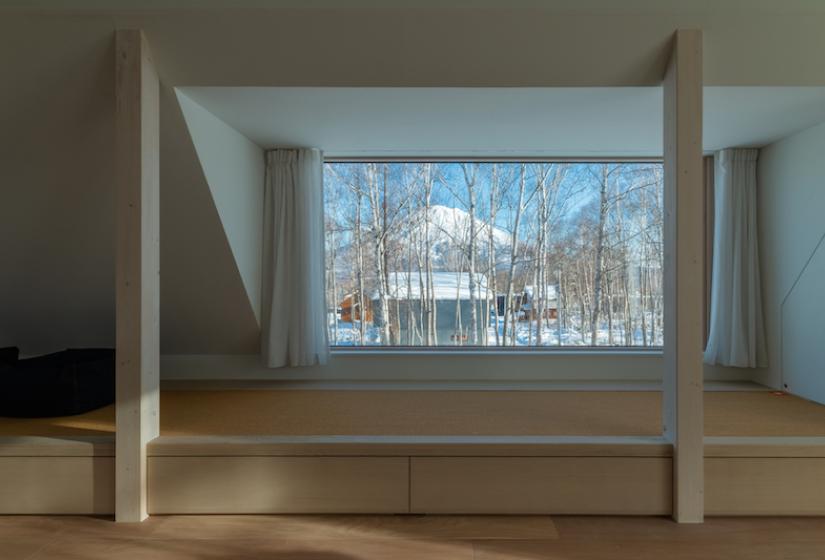 A view of yotei through trees through a rectangle window