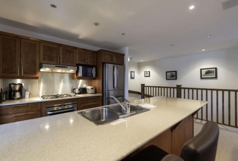 Kitchen island bench with stove top behind