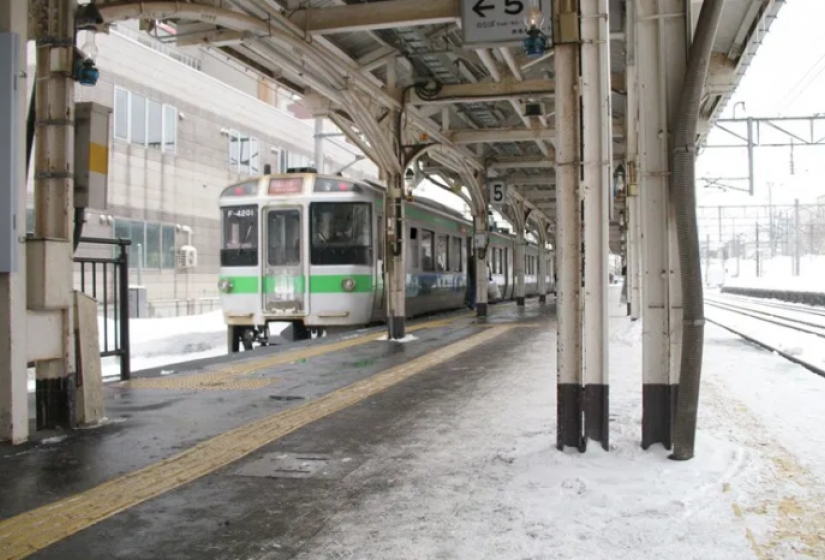 A JR train at a snowy station