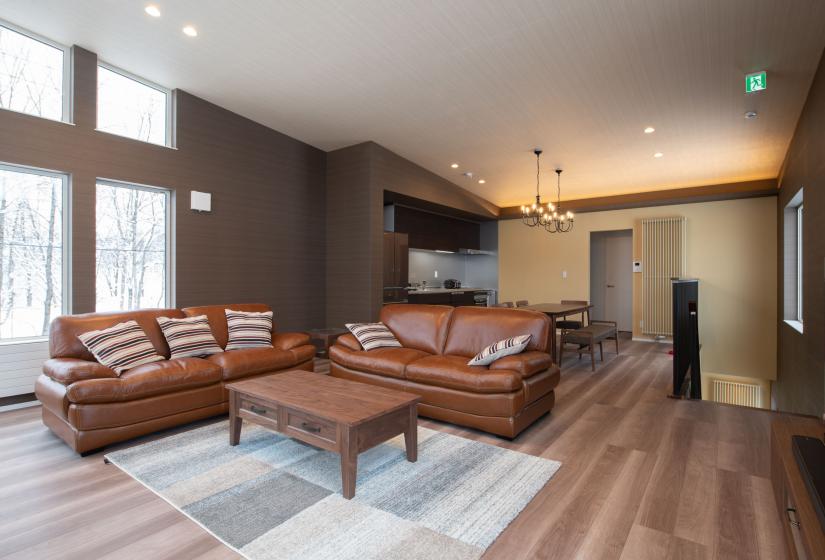 two brown leather sofas and brown coffee table