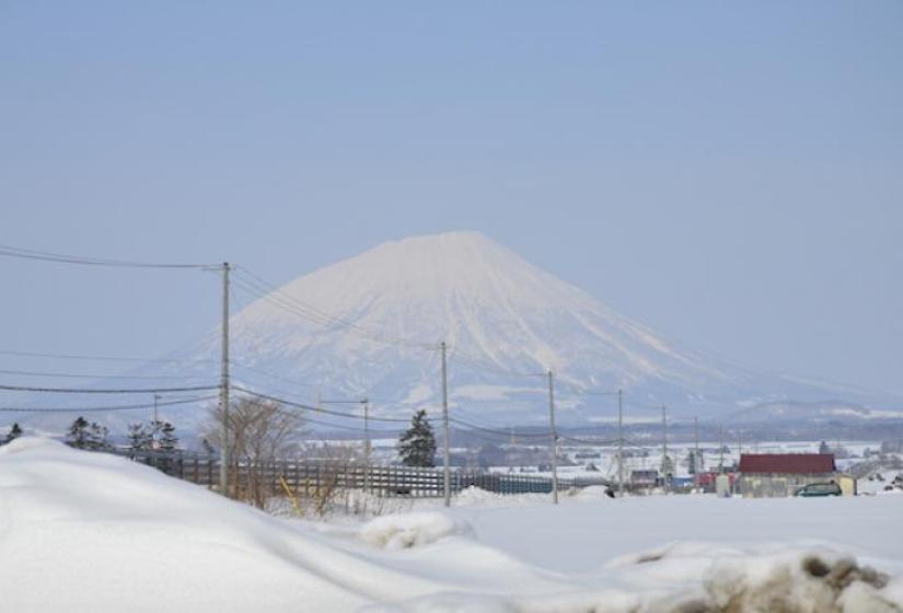 A view of Mount Yotei intersected by powerlines