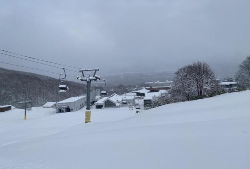 A chair lift above a large powder field