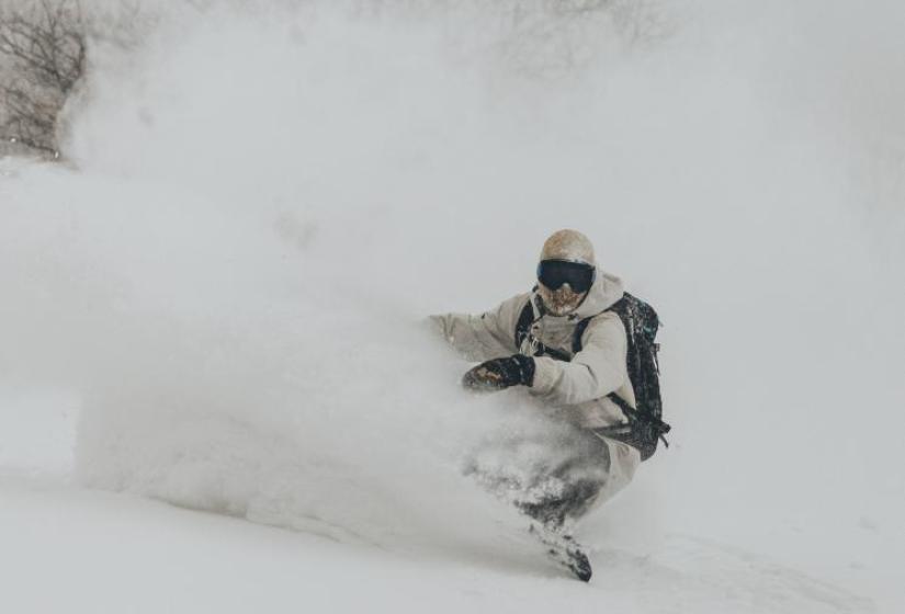 Snowboard turn A snowboarder digging a deep powder turn