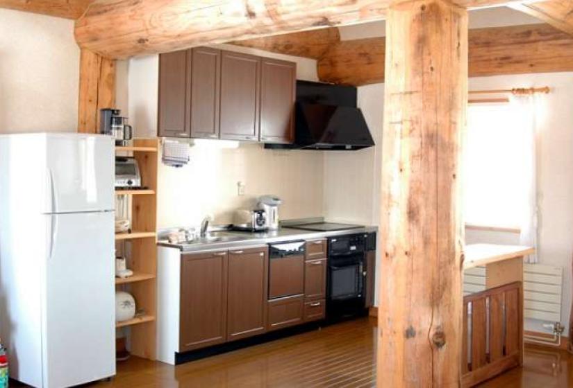 kitchen with oven, stove, dish washer and exposed wood beam