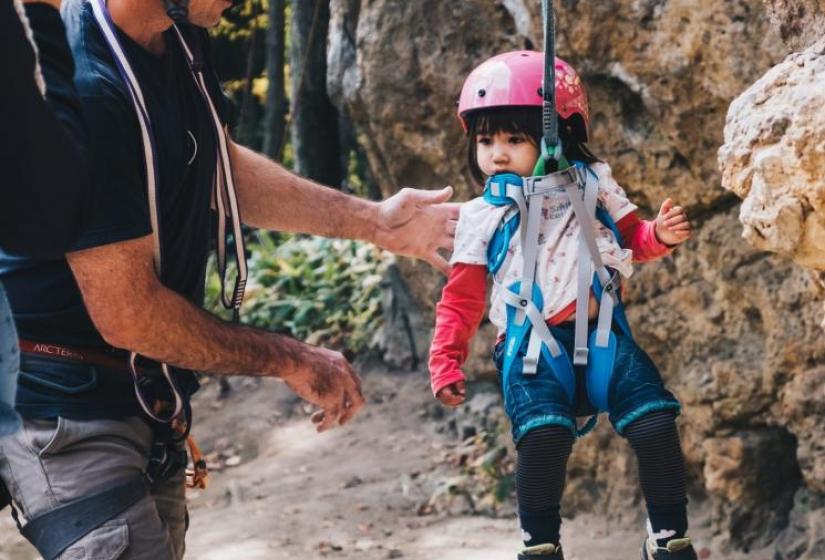 Rock climbing runs in the family Trevors daughter swings in a rock climbing harness
