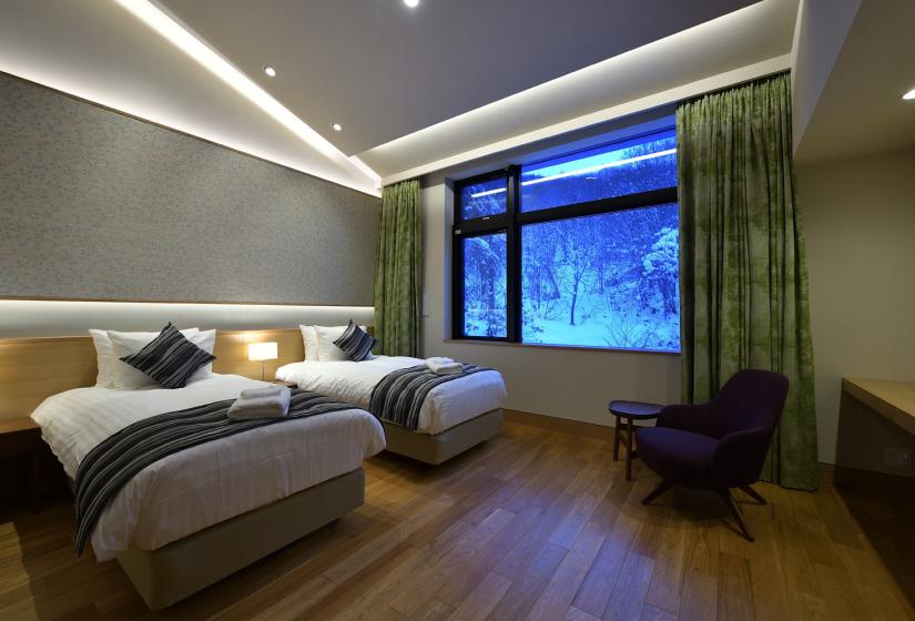 Two single beds with ceiling lights above