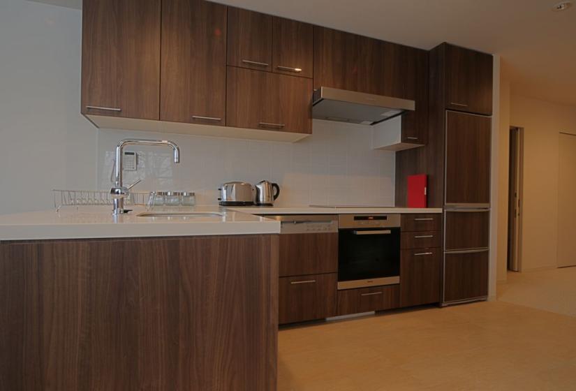 wooden kitchen cabinets, large oven and stovetop