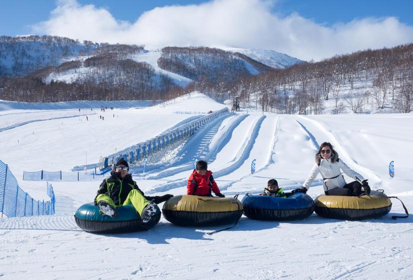 A family snowtubing at Hanazono ski area