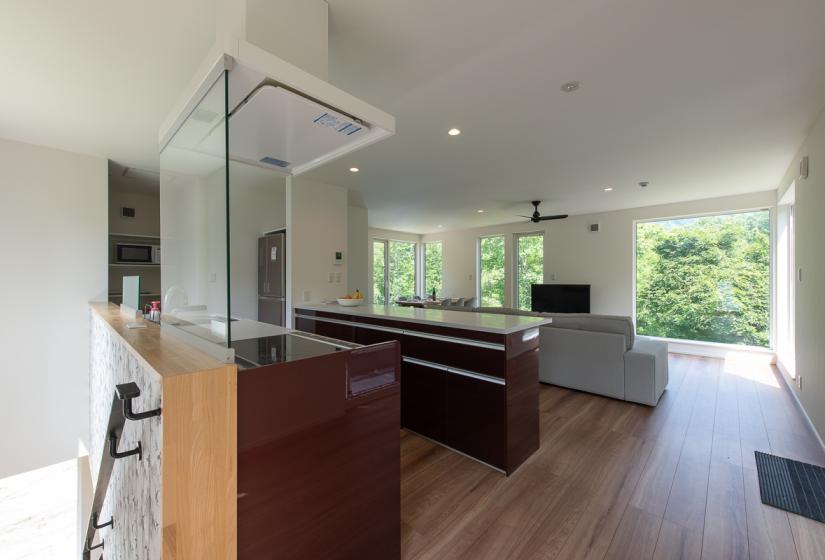 A kitchen island bench and lounge suite in an open plan room