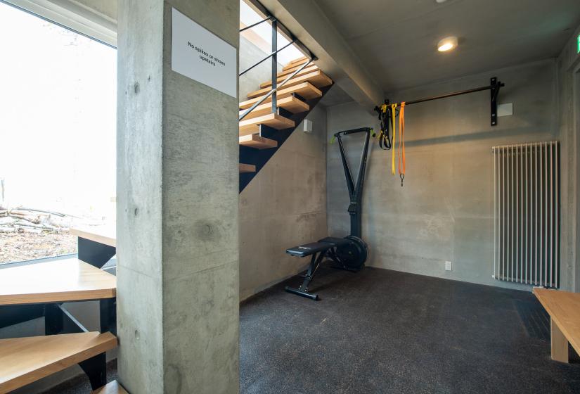 A house entry way with gym equipment and stairs to left.