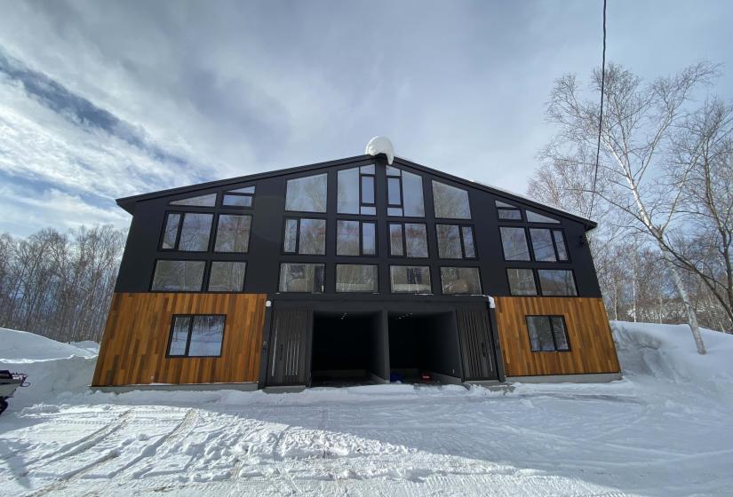 A large 2 bedroom duplex with two garages and steel and wooden cladding
