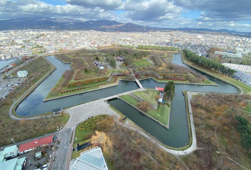 A large star shaped moat surrounding a castle grounds shot from above