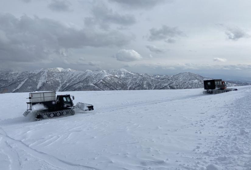 The journey is certainly half of the experience but the destination is something else again. Two snow cats aith mountains in the back ground