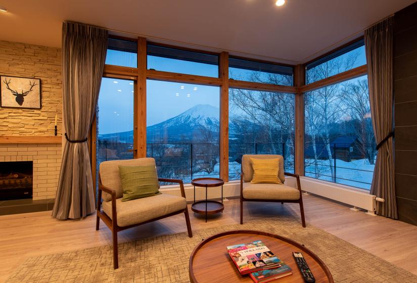 Two sets in front of large window with mountain view