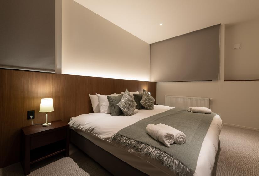 Double bed with grey throw
