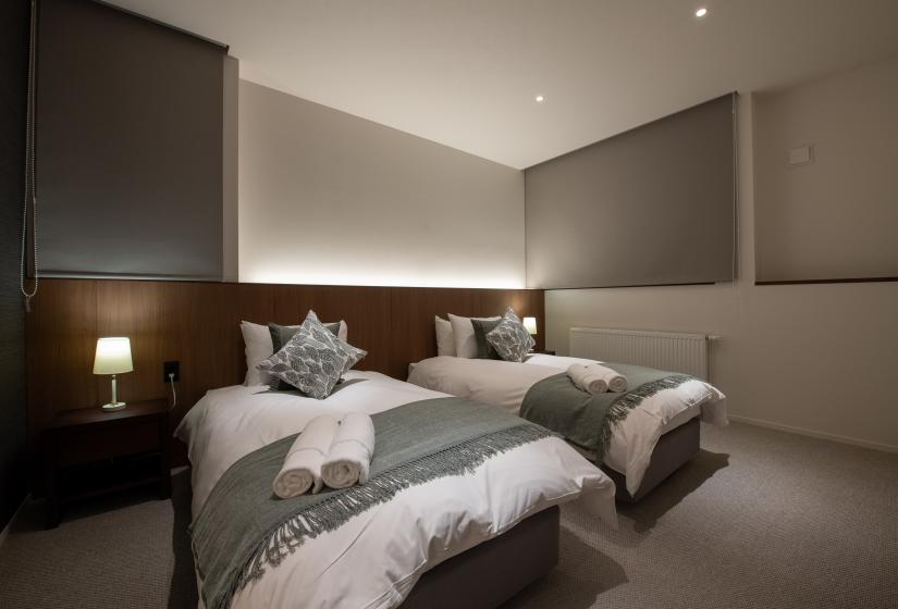 Two single beds with grey throws