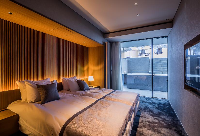 Large bedroom with double bed and steps to the ski field