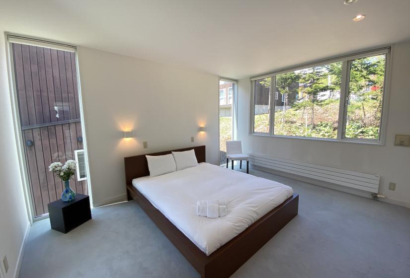 A double bed with flowers to the left