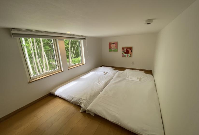 Futon bedding in a loft with windows