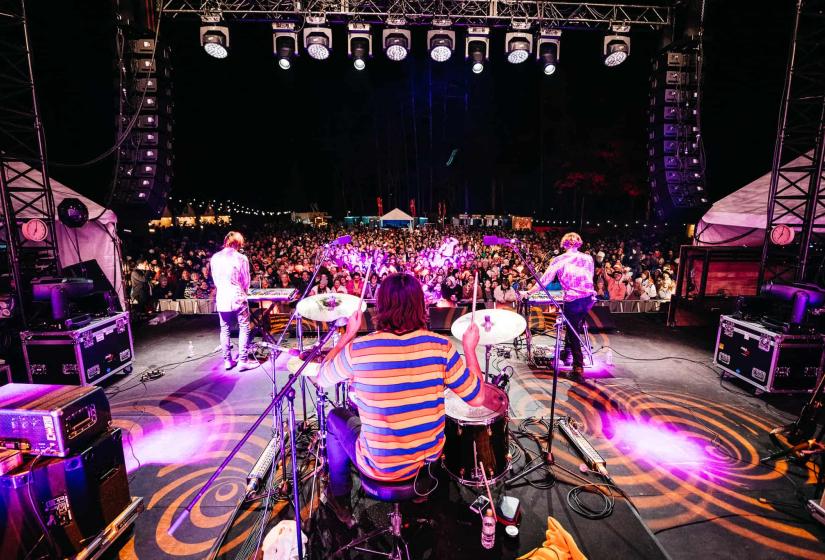 A band on a stage in front of a large crowd