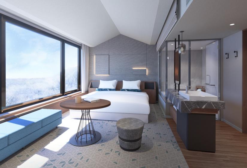A double bed with windows to the left
