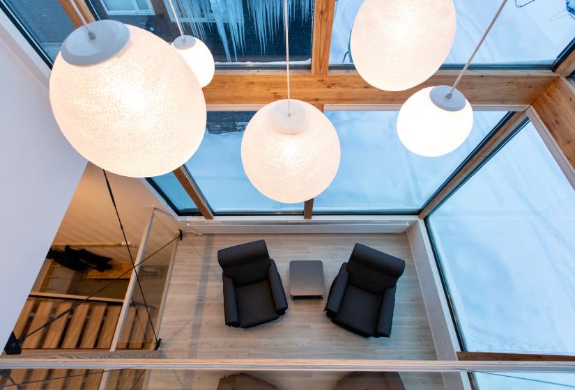 Hanging lights above two arm chairs 