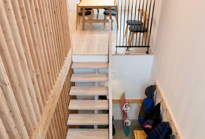 A stairway and ski rack below