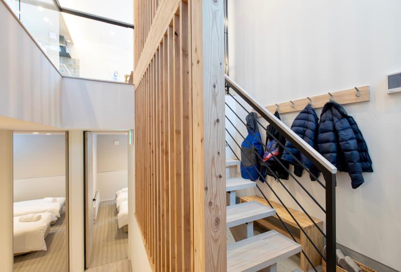 A stairway and jackets hanging to the right