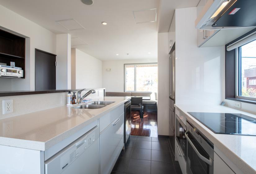 A white kitchen with silver oven