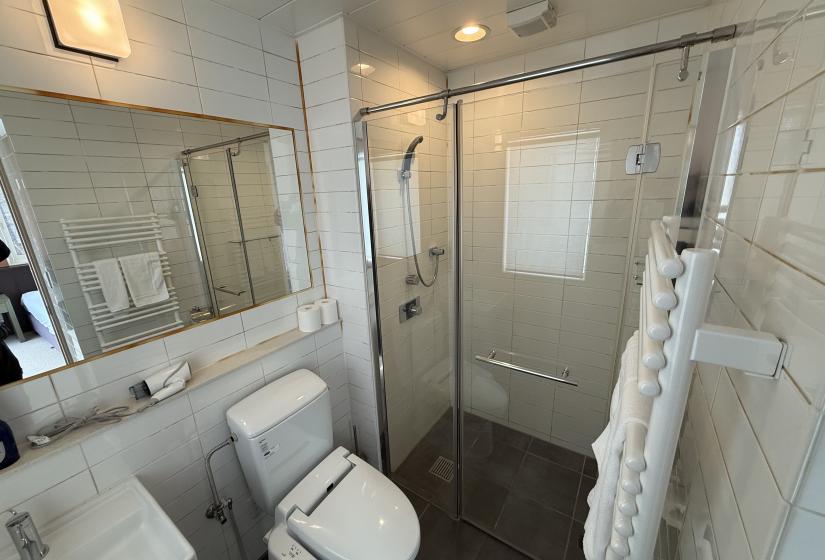 Sleek ensuite bathroom at Yutaka Townhouses Niseko ski accommodation featuring Japanese washlet toilet, glass walk-in shower, and contemporary design perfect for winter ski holidays.