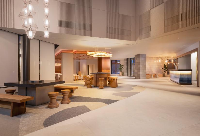 A spacious hotel lobby with earthy tones